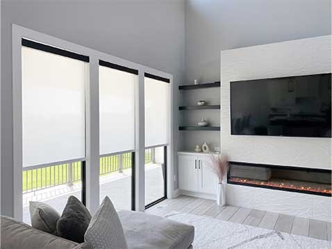A modern living room, showing off 3 shaded windows