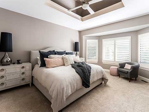 Bedroom showcasing window shutters